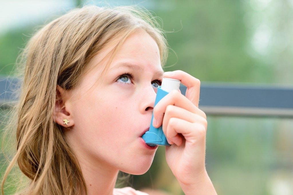 Little girl using an inhaler