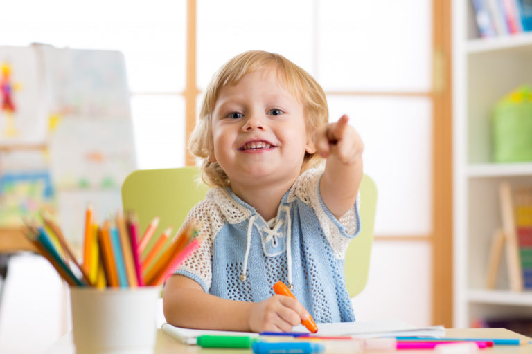 a kid playing with crayons