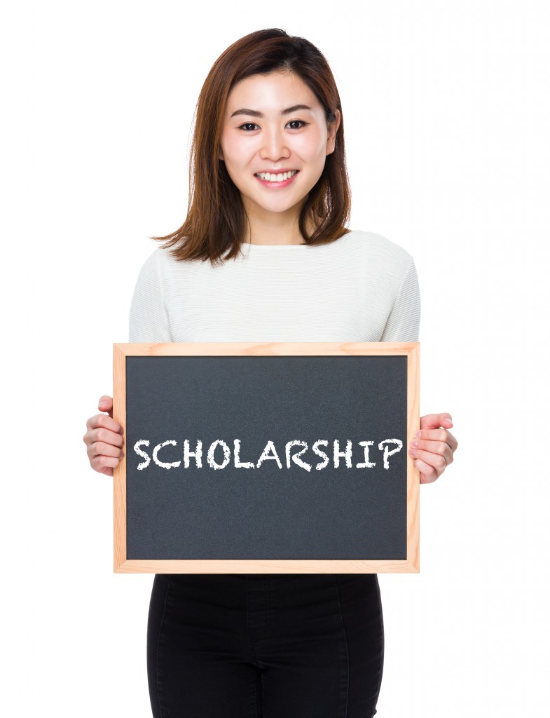 person holding scholarship in board