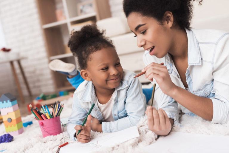 mother teaching her daughter about colored pencils